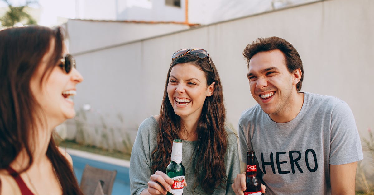 A confident man engaged in genuine conversation with friends at a social gathering, representing the social confidence that comes with recovery.