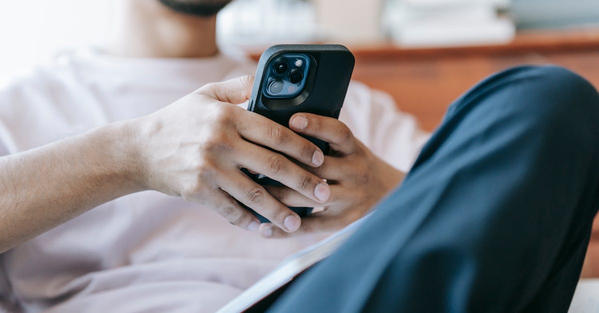 A confused man sitting at a desk, looking at his phone with multiple browser tabs open, representing the overwhelming and contradictory advice available about porn addiction online.
